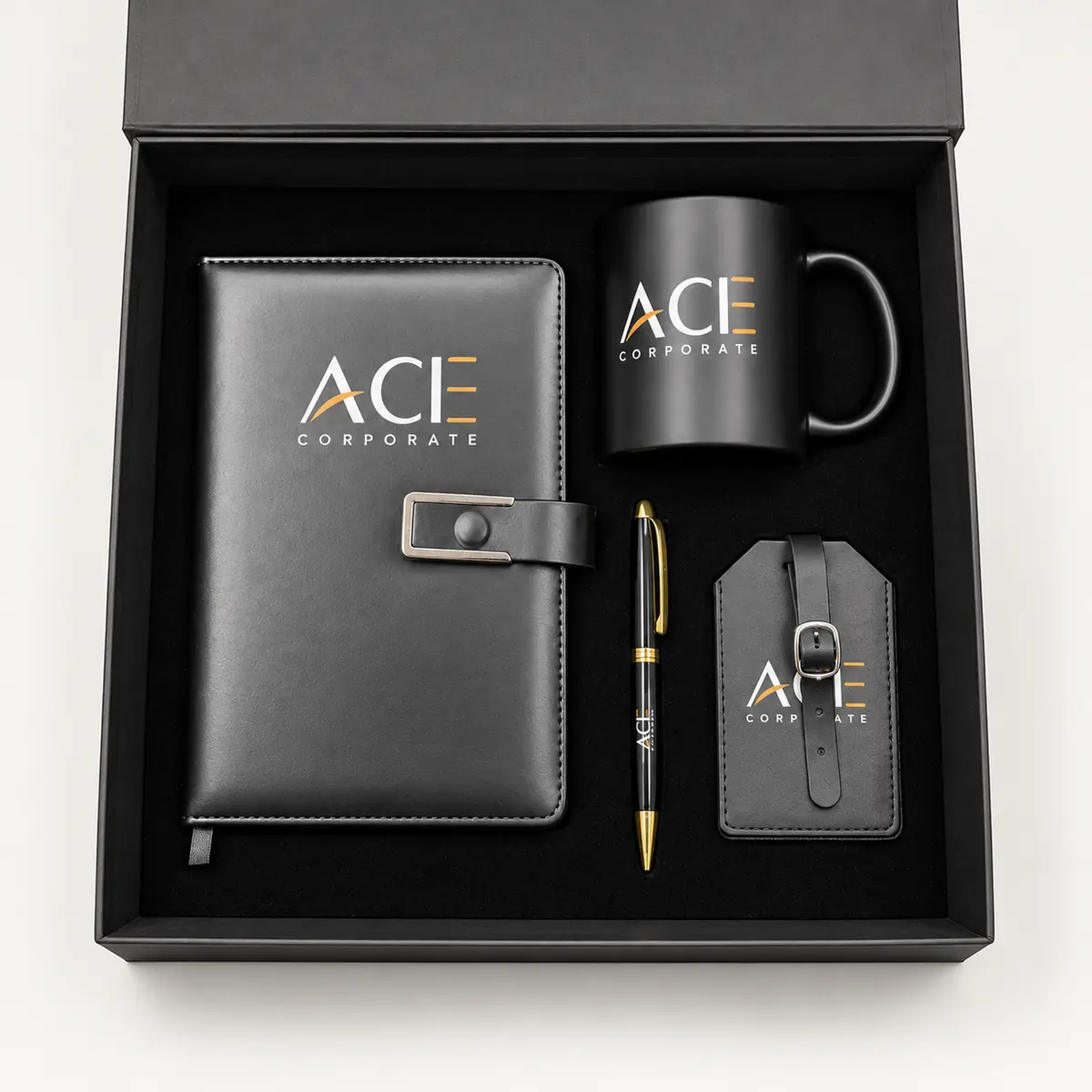 Black presentation gift box with a strap-closure organizer, ceramic mug, metal pen and luggage tag